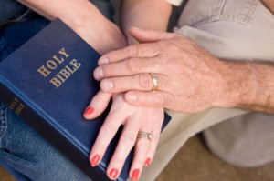 couple hands bible